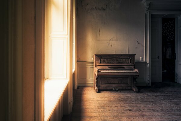 An empty room with an old piano