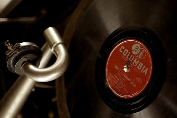 On the gramophone is a Columbia studio record with a red sticker