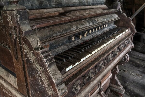 An ancient organ covered with dust and cobwebs