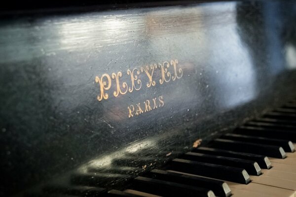 An old piano with a beautiful inscription