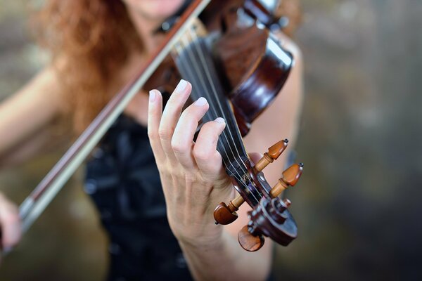 Fille en robe jouant du violon