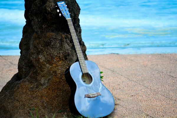 Guitar at the cliff on the river bank