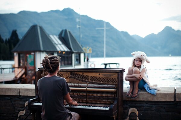 Sunset in New Zealand. Piano and a girl in a hat