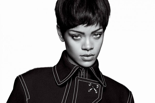 Rihanna in a stylish coat in a black and white photo