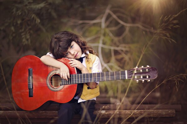 Dina Telhami is sitting with a guitar