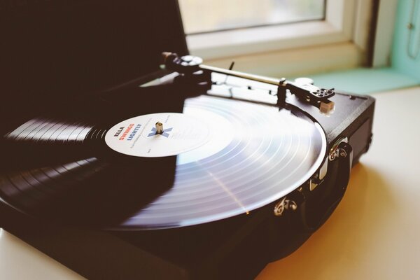 A vinyl record on the turntable. Phonograph