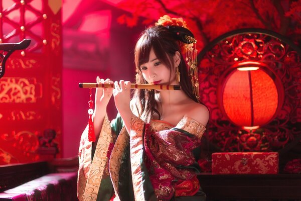 A geisha girl playing a pipe