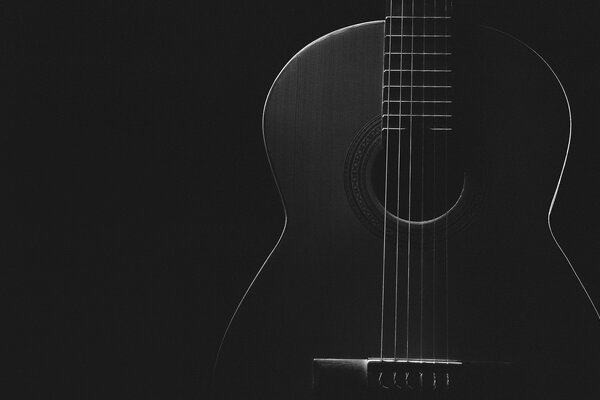 Black and white guitar on a black background