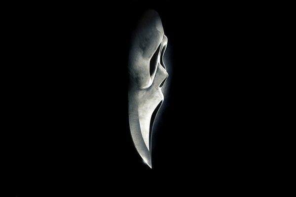 Scream mask on black background