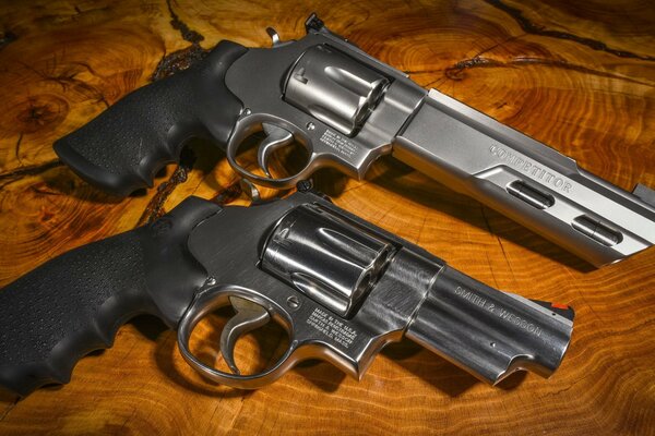 Two revolvers on a wooden table