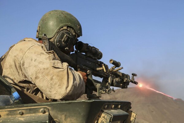 A marine firing a submachine gun