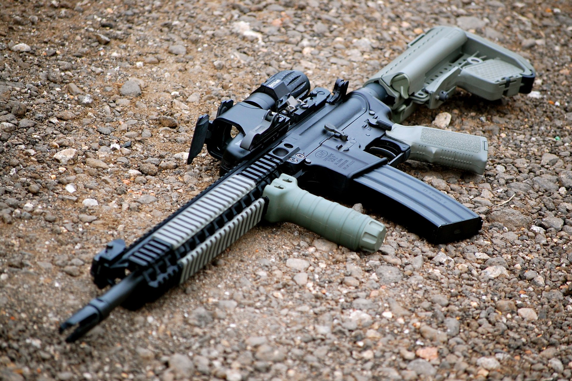 ar-15 assault rifle machine weapon gravel