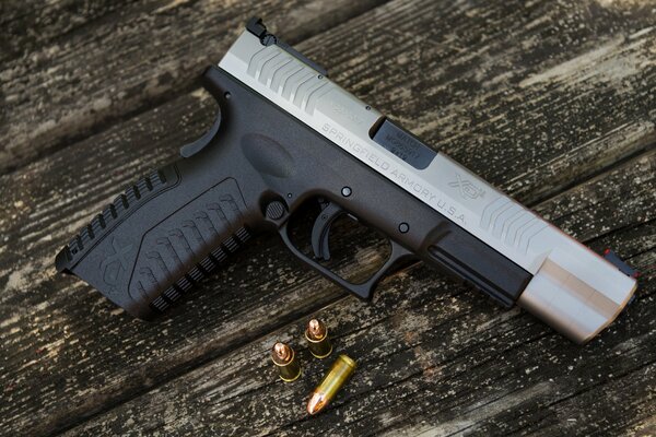 Semi-automatic pistol and cartridges on the table