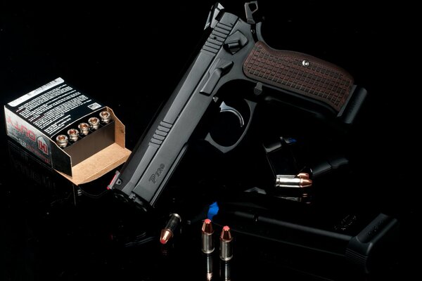 Pistol with cartridges on a black background