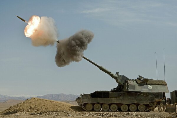 A tank fires from an artillery installation