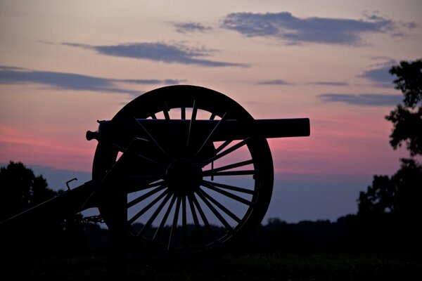 Cannon on the background of a pink sunset