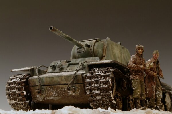 A toy tank and two fighters on a gray background