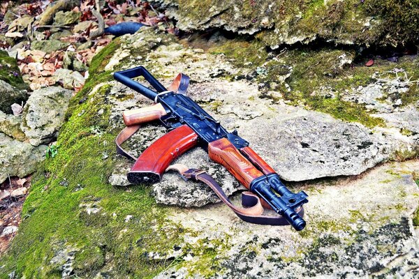 Kalashnikov assault rifle on the rocks