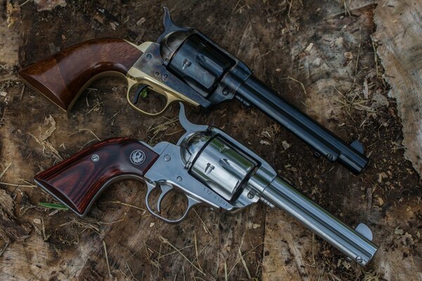 Two revolvers are lying on the ground