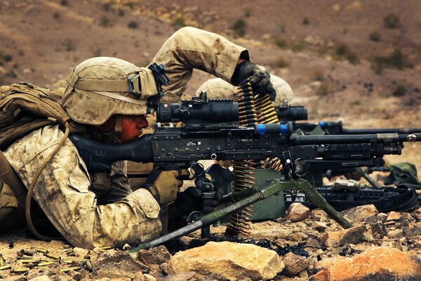 Soldiers with a machine gun are ready to shoot