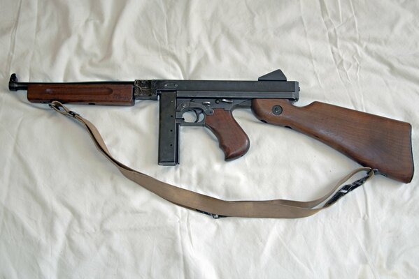 Thompson s submachine gun is lying on a sheet