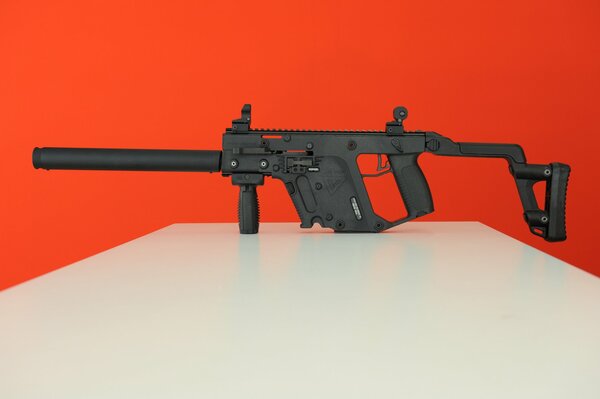 Machine gun on a red background. Weapon