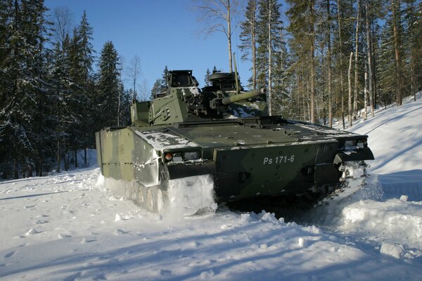 Un véhicule de combat roule sur la neige