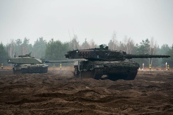 Armored vehicles ride on uneven ground