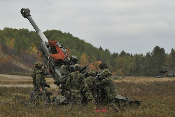 Soldiers in the field with weapons on exercises