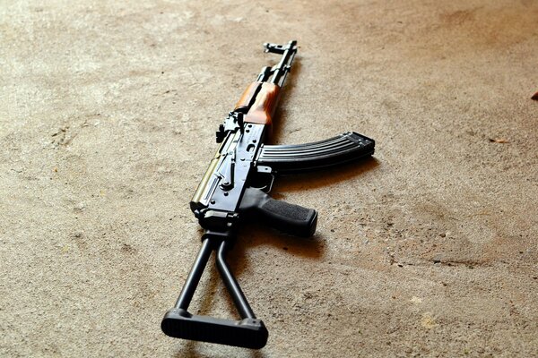 The Kalashnikov assault rifle is lying on the concrete