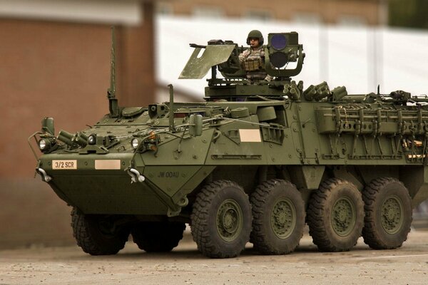 Armored personnel carrier drives through the streets of the city