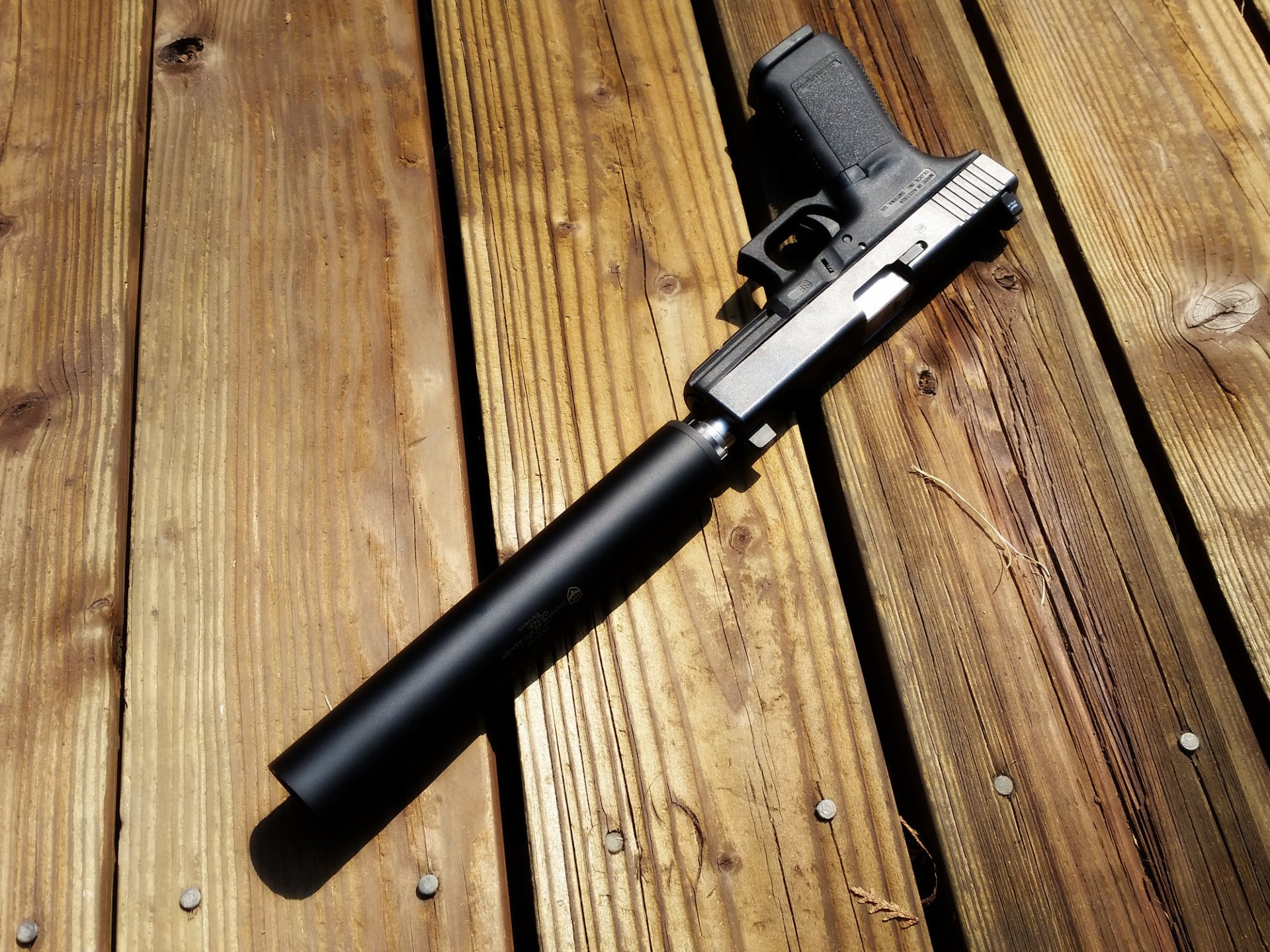 glock 21 gun with a silencer silencer board shadow