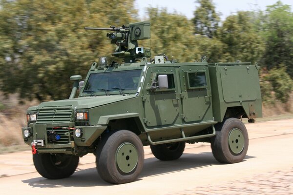 Armored car on a sandy road near the forest