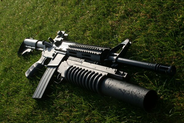 Weapons on the grass. M203 under - barrel grenade launcher