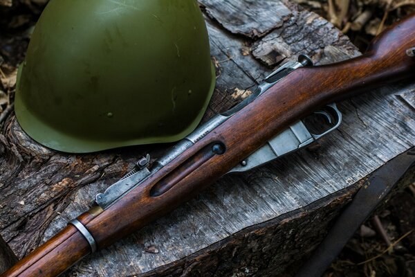 Das Mosin-Gewehr und der Helm liegen auf dem Tisch