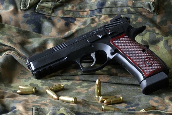 CZ75 sp01 pistol with cartridges lying nearby