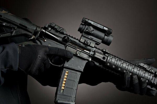 M4 machine gun in hands black background photo