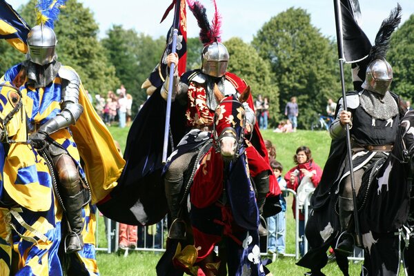 Historical reconstruction of knights in armor on horseback