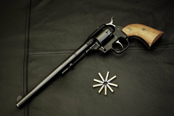 A revolver on a black background and nine rounds of ammunition