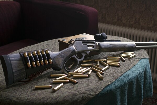 The carbine is lying on the table with scattered cartridges