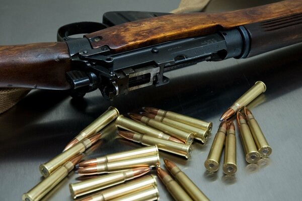 Image of a rifle with cartridges. Many