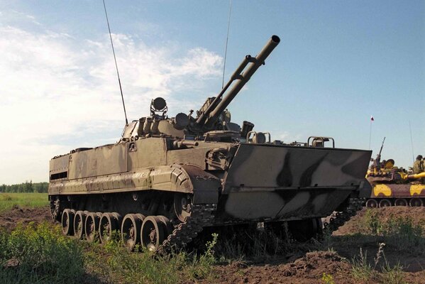 BMP-3 combat vehicle on the background of the sky and green grass