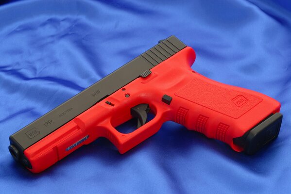 Red gun on blue fabric