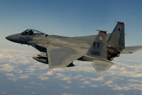 F - 15 fighter flying among the clouds