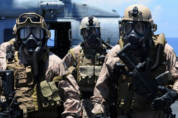 Soldiers on the background of a helicopter in gear