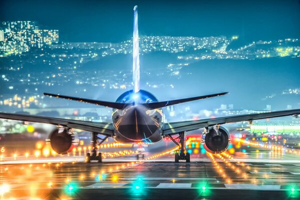 Airplane and night lights of airport and city