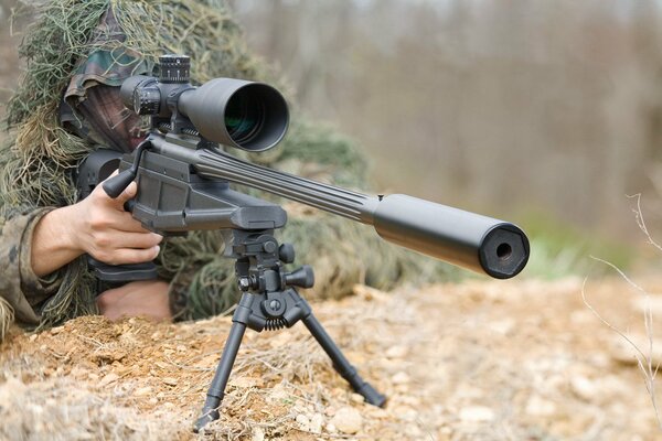 Sniper in ambush on a rocky mountain