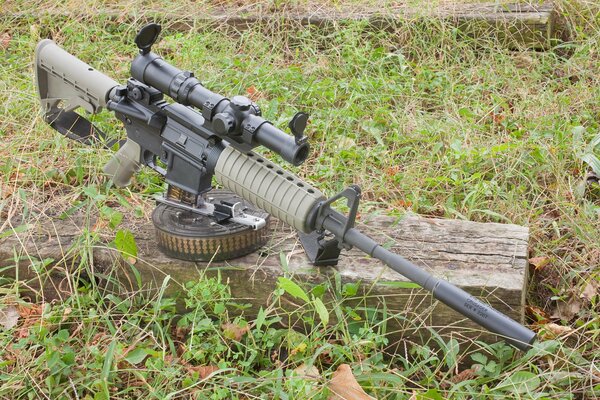 M4 autocar with a carbine on a wooden log