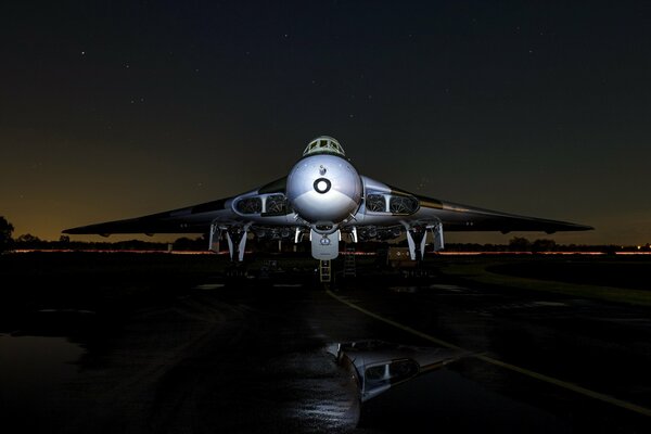 Bomber aircraft at night on the runway under the starry sky