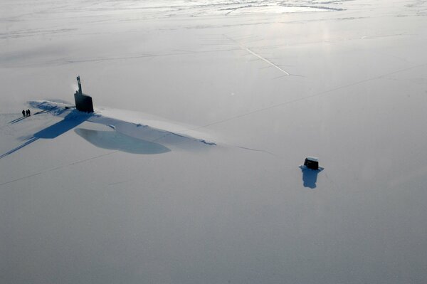 Frozen in the ice, the submarine breaks it with its power